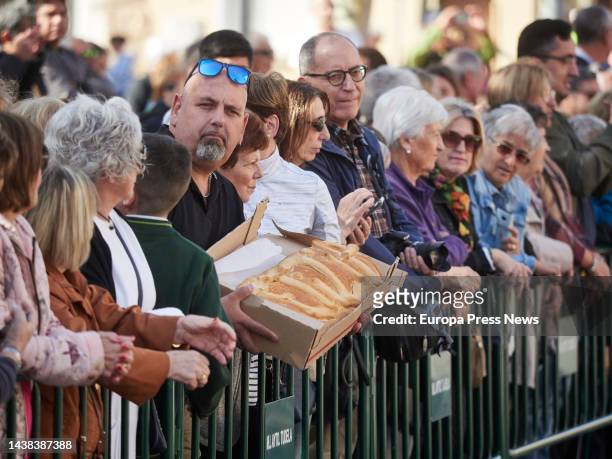Man shows a loaf of bread as Queen Letizia leaves the 22nd edition of the 'Festival de Cine Opera Prima Ciudad de Tudela', at the Cine Moncayo, Nov....