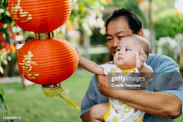 grandfather and grandson bonding during chinese new year holiday - kinesiska lyktfestivalen bildbanksfoton och bilder