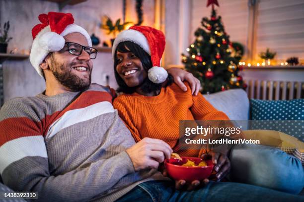 young couple enjoying together at home - christmas movie stock pictures, royalty-free photos & images
