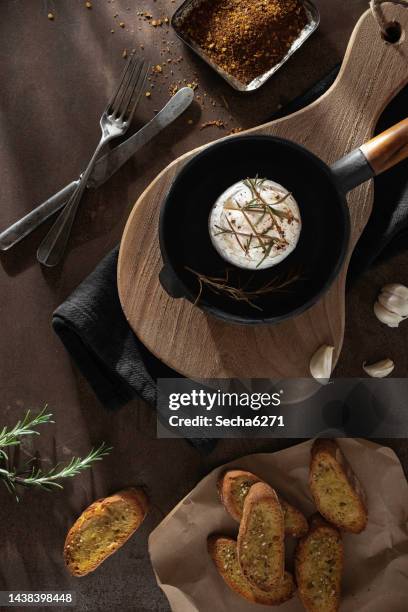 baked camembert cheese with garlic, rosemary and honey - baked brie stock pictures, royalty-free photos & images