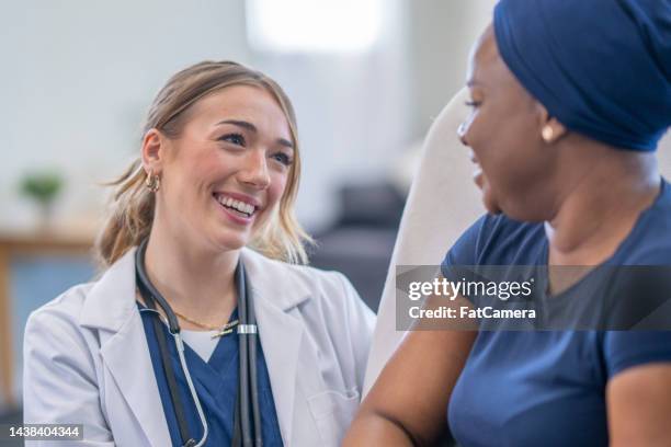 oncologist doing a homecare visit - nurse smiling stock pictures, royalty-free photos & images