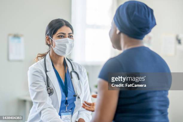 cancer patient at a check-up - female doctor with mask stock pictures, royalty-free photos & images