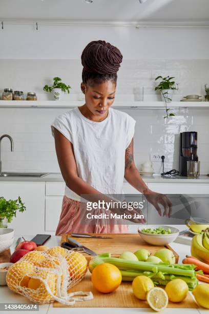 a woman cutting fresh vegetables, preparing healthy food - cooking healthy stock pictures, royalty-free photos & images
