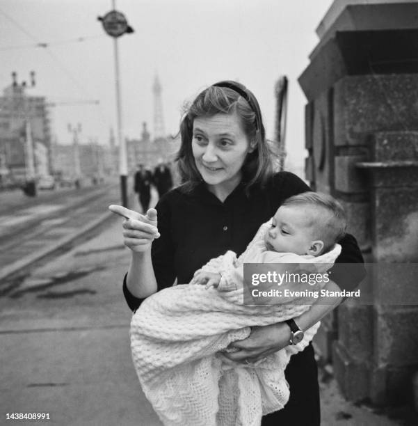 British politician Shirley Williams holding her baby daughter Rebecca outside the Labour Party Conference in Blackpool, October 3rd - 6th, 1961.