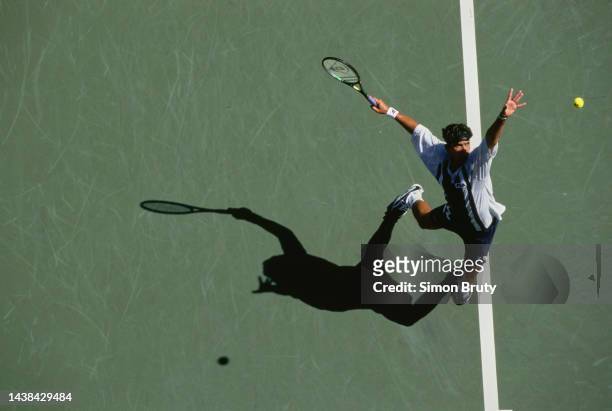 Mark Philippoussis from Australia keeps his eyes on the tennis ball as he serves to Andrei Olhovskiy of Russia during their Men's Singles Second...