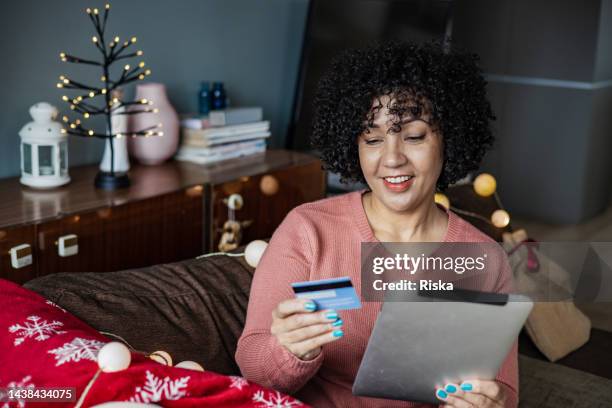 mature woman doing online christmas shopping - cybersecurity month stock pictures, royalty-free photos & images