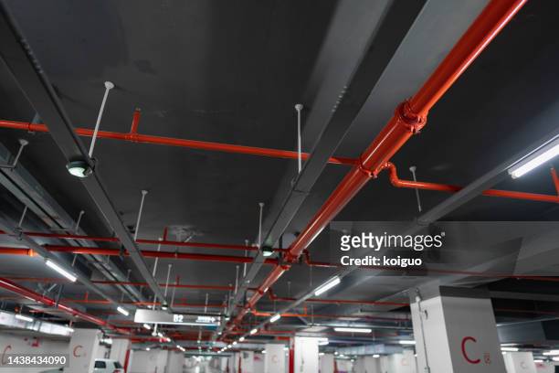ceiling red fire hose - fire sprinkler stock pictures, royalty-free photos & images