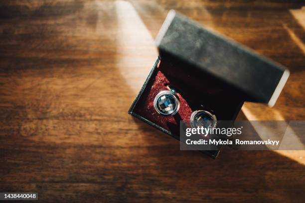 cufflinks in black box on wooden surface. - manschettenknöpfe stock-fotos und bilder