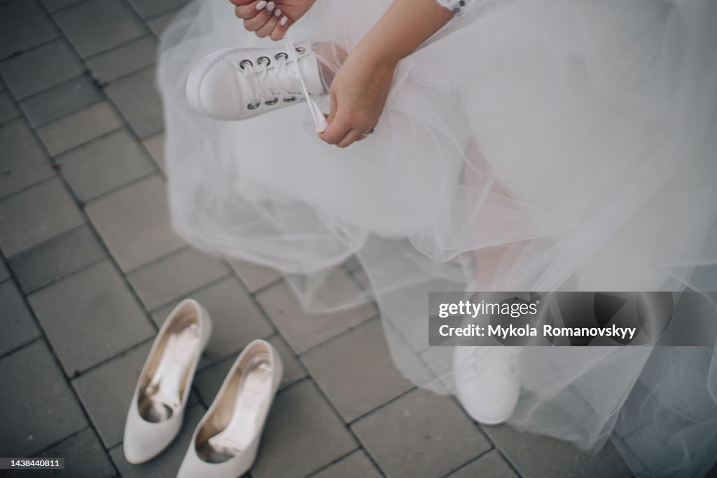 Bride changing the shoes.
