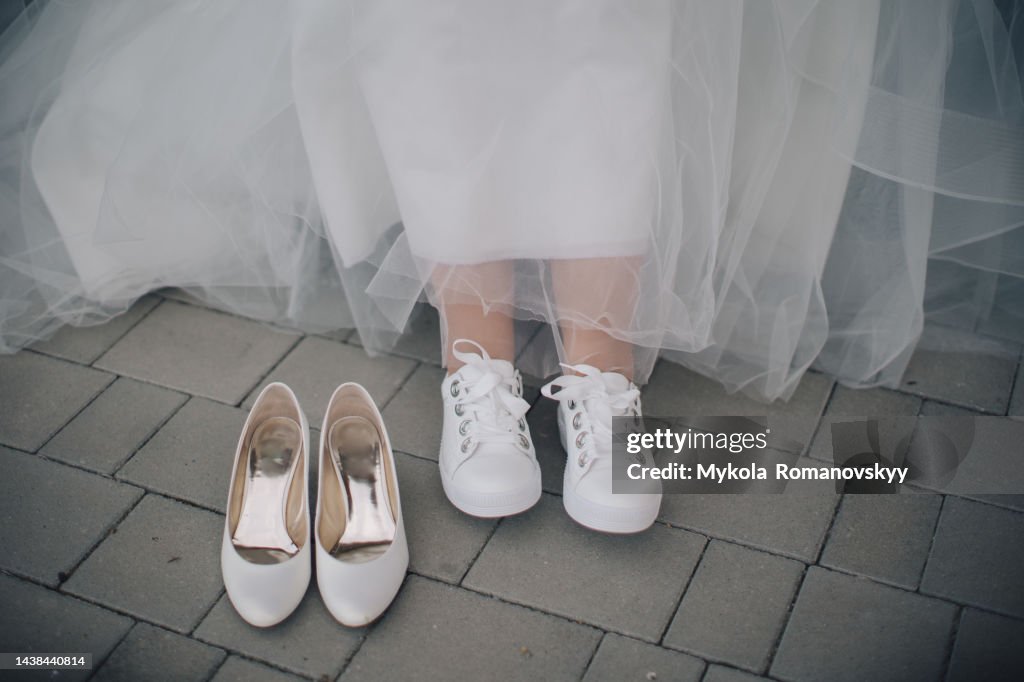 Bride changing the shoes.
