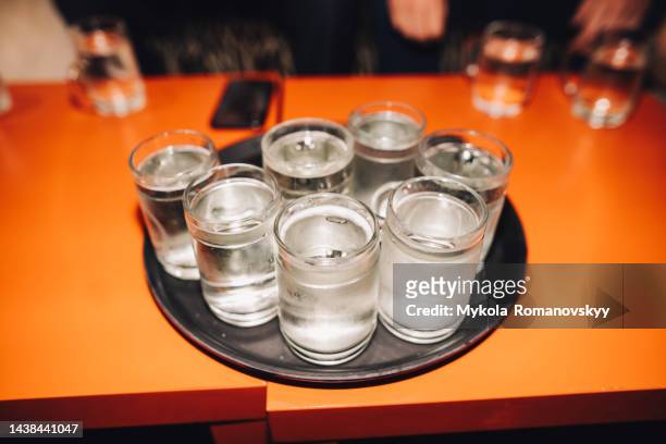 seven shots of schnapps on the tray. - grappa stock pictures, royalty-free photos & images