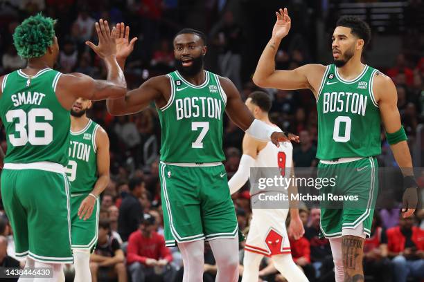 Marcus Smart, Jaylen Brown and Jayson Tatum of the Boston Celtics celebrate against the Chicago Bulls during the first half at United Center on...