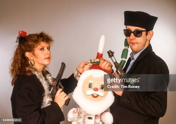Portrait of British musician Kirsty MacColl and Irish musician Shane MacGowan, the latter of the group the Pogues, as they pose together, each...