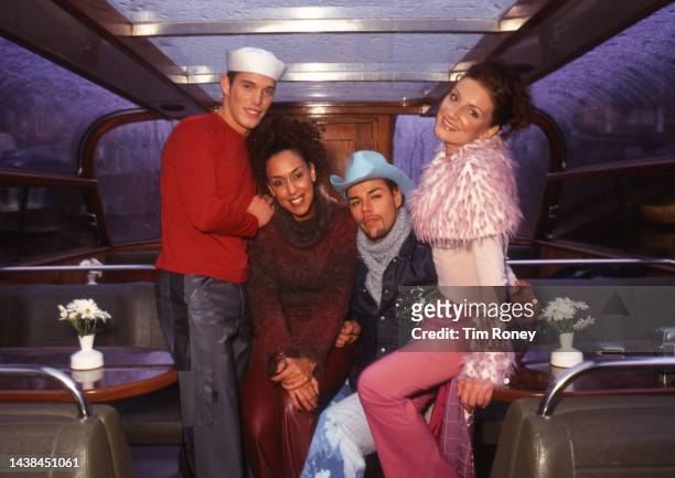 Portrait of members of Dutch dance and Pop group Vengaboys as they pose on canal boat, Amsterdam, Netherlands, 2000s.