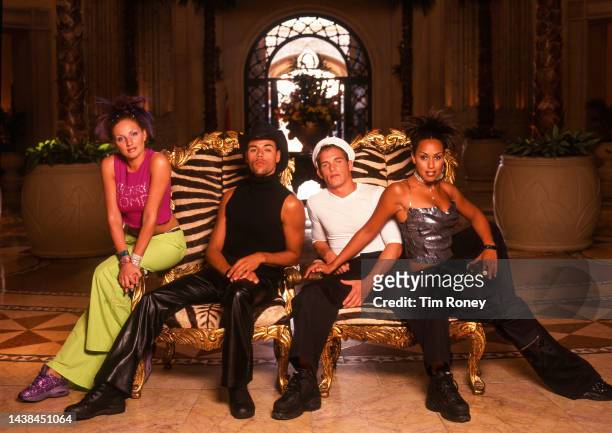 Portrait of members of Dutch dance and Pop group Vengaboys as they pose on zebra-print armchairs in a lobby, South Africa, circa 2000.