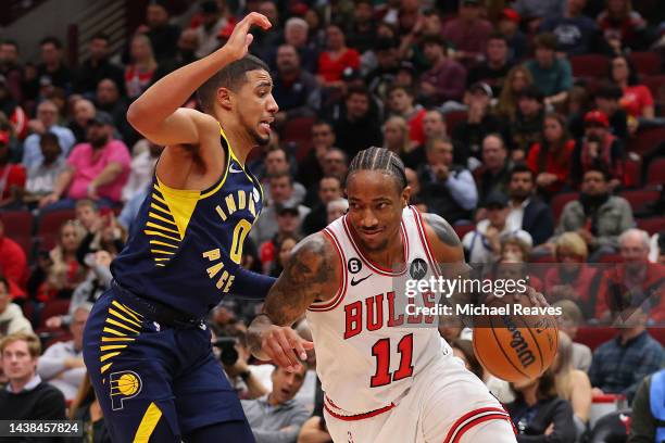 DeMar DeRozan of the Chicago Bulls dribbles against Tyrese Haliburton of the Indiana Pacers during the second half at United Center on October 26,...