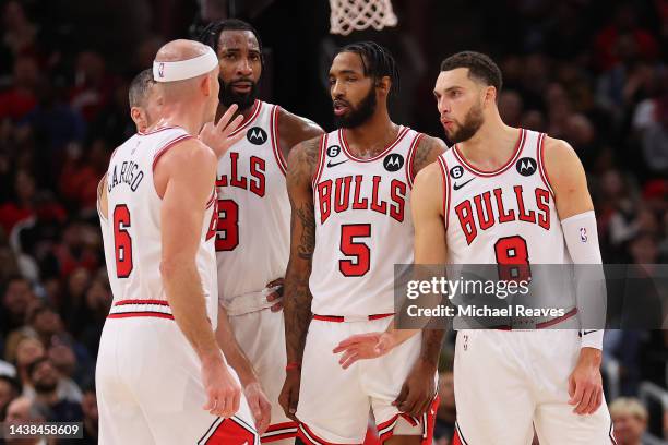 Alex Caruso, Andre Drummond, Derrick Jones Jr. #5, and Zach LaVine of the Chicago Bulls huddle against the Indiana Pacers during the second half at...