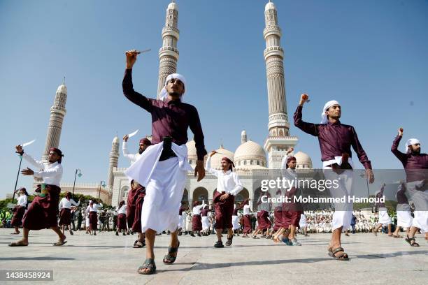 Yemenis dance during a collective wedding ceremony on October 31, 2022 in Sana'a, Yemen.