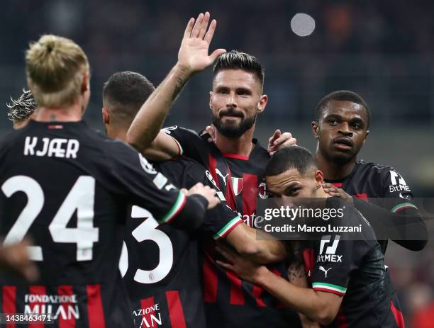 Olivier Giroud of AC Milan celebrates with teammates after scoring their team's first goal during the UEFA Champions League group E match between AC...