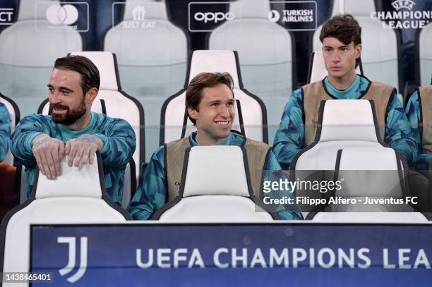 Carlo Pinsoglio, Federico Chiesa and Matias Soule of Juventus look on from the bench prior to the UEFA Champions League group H match between...