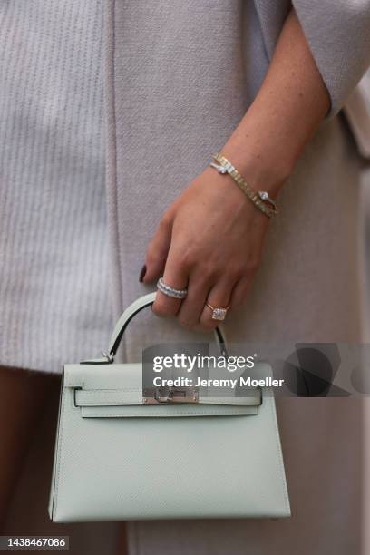 Leo Eberlin wearing Zara beige coat, H&M beige knit sweater dress, Hermes light green mini leather Kelly bag, Rolex gold Oyster Daydate watch and Leo...