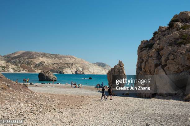 tourists and local residents resting on beach of the aphrodite's rock, or petra tou romiou , in paphos , cyprus - limassol cyprus stock pictures, royalty-free photos & images