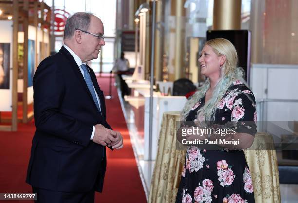 Prince Albert II of Monaco talks with first prize Environmental Photography Award winner Kathleen Ricker during his visit to the "Humanity &...