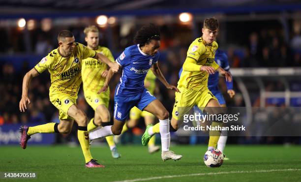 Tahith Chong of Birmingham City runs past Jake Cooper and Charlie Cresswell of Millwall during the Sky Bet Championship match between Birmingham City...