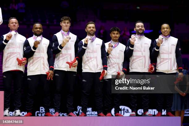 Bronze medalist of Team Great Britain pose for a photo during the medal ceremony for the Men's Team Final on day five of the 2022 Gymnastics World...