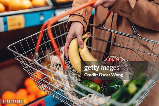 Young woman shopping vegetables in supermarket Young woman shopping vegetables in supermarket