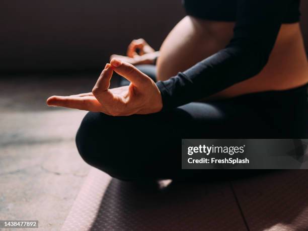 anonymous pregnant woman meditating - girly pregnant stock pictures, royalty-free photos & images