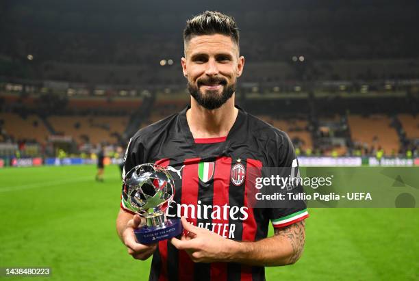Olivier Giroud of AC Milan poses for a photo with the PlayStation Player Of The Match trophy after their sides victory during the UEFA Champions...