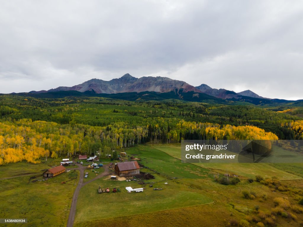 High Drone View of Historic Mountain Ranch in Southwest Colorado in the San Juan Range of the Rocky Mountains Near Telluride with Vibrant Fall Colors on the Trees