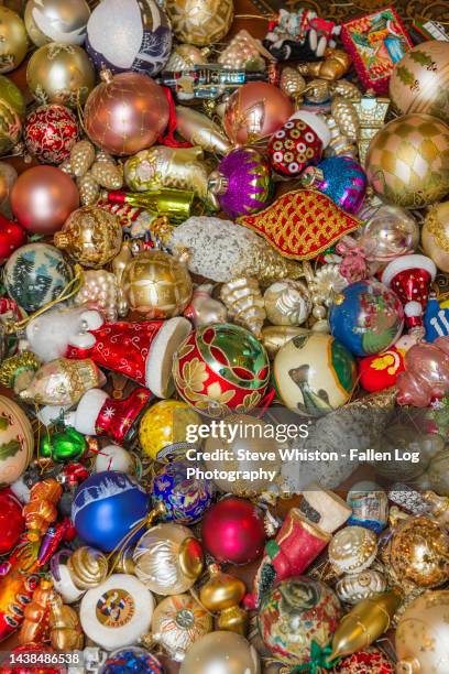 close up view of many shiny and glittery christmas ornaments as seen from above - santa close up stock-fotos und bilder
