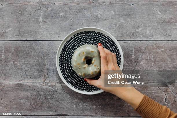 delicious home made doughnut served with a ceramic plate on a doodle table - fat people eating donuts foto e immagini stock