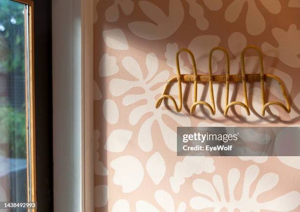 rattan coat hanger by back door of house with sun shinning on it - wolf wallpaper stock pictures, royalty-free photos & images