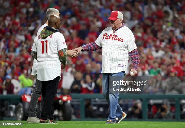 Jimmy Rollins, Chase Utley and Charlie Manuel meet on the field to delivers the first pitches prior to the start of Game Four of the 2022 World...