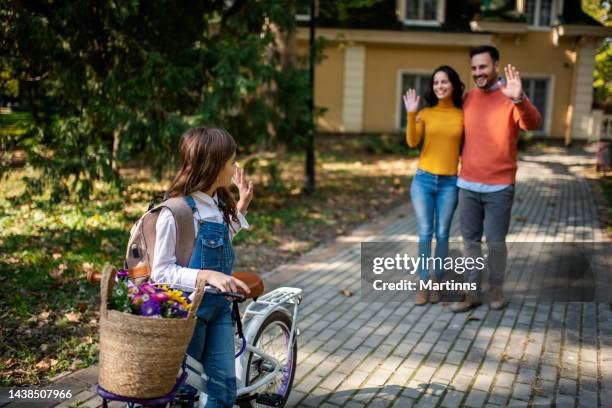 parents send their daughter to school - child waving stock pictures, royalty-free photos & images