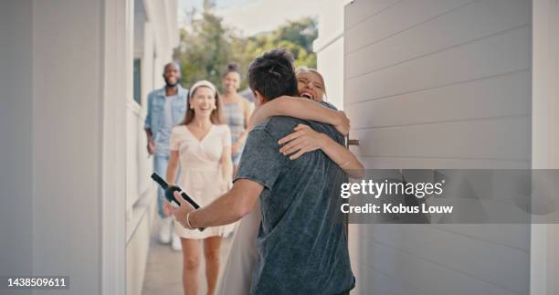reunion, home and excited friends hug with bottle of wine for house party, opening door for celebration and success of diversity. group of people hello with alcohol for welcome and happy housewarming - friends at the door stock pictures, royalty-free photos & images