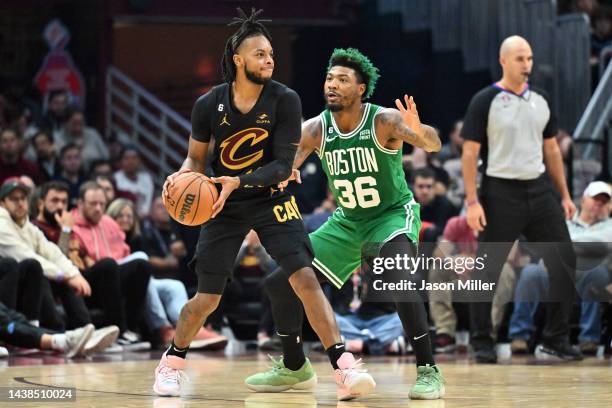 Darius Garland of the Cleveland Cavaliers runs a play while under pressure from Marcus Smart of the Boston Celtics d2q at Rocket Mortgage Fieldhouse...