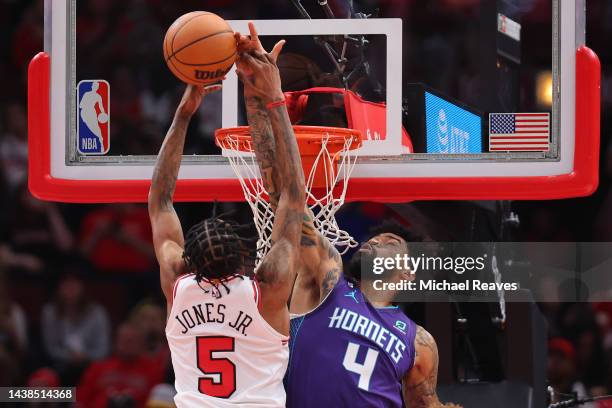 Nick Richards of the Charlotte Hornets blocks a dunk attempt by Derrick Jones Jr. #5 of the Chicago Bulls during the first half at United Center on...