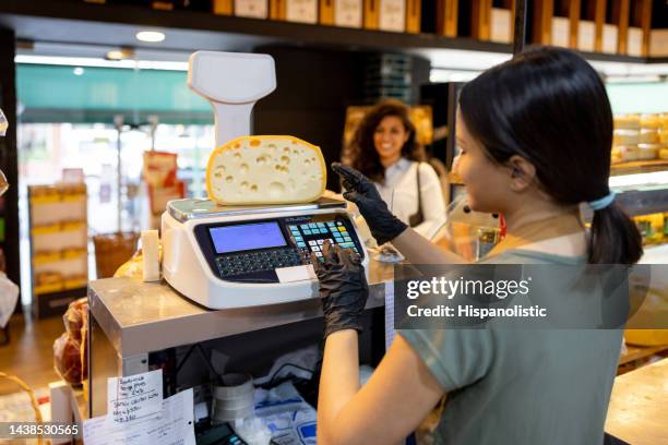 woman selling cheese at the delicatessen - looking from rear of vehicle point of view stock pictures, royalty-free photos & images