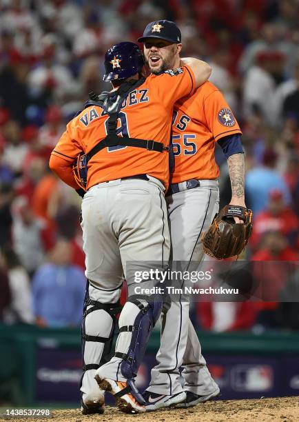 Christian Vazquez and Ryan Pressly of the Houston Astros celebrate a combined no-hitter to defeat the Philadelphia Phillies 5-0 in Game Four of the...