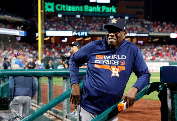 Manager Dusty Baker Jr. #12 of the Houston Astros smiles in the dugout after the Astros defeated the Philadelphia Phillies 5-0 to win Game Four of...