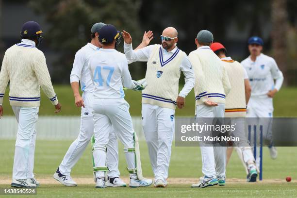 Nathan Lyon of NSW celbrates taking a wicket with team mates during the Sheffield Shield match between New South Wales and South Australia at North...
