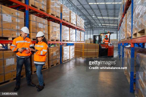 managers controlling distribution and checking inventory in warehouse storage. - storage solutions stock pictures, royalty-free photos & images
