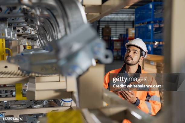 a day at work for a male and female engineers working in a metal manufacturing industry. - part of stockfoto's en -beelden