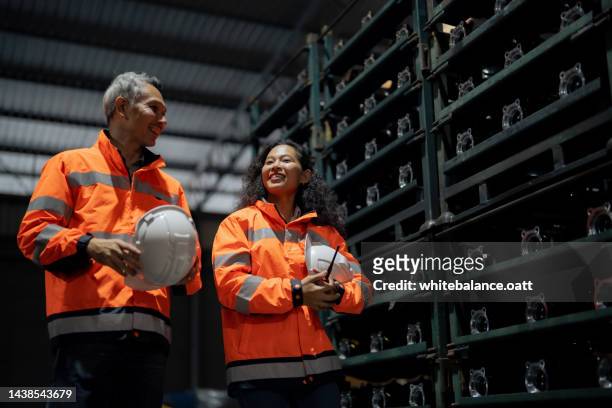 mechanic and female engineer talking in factory. - software as a service stock pictures, royalty-free photos & images