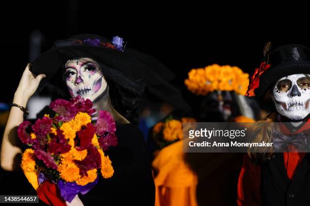 People dressed as Catrinas, Mexico's lady of death who serves as a reminder to enjoy life and embrace mortality, attend the Día De Muertos Camino al...
