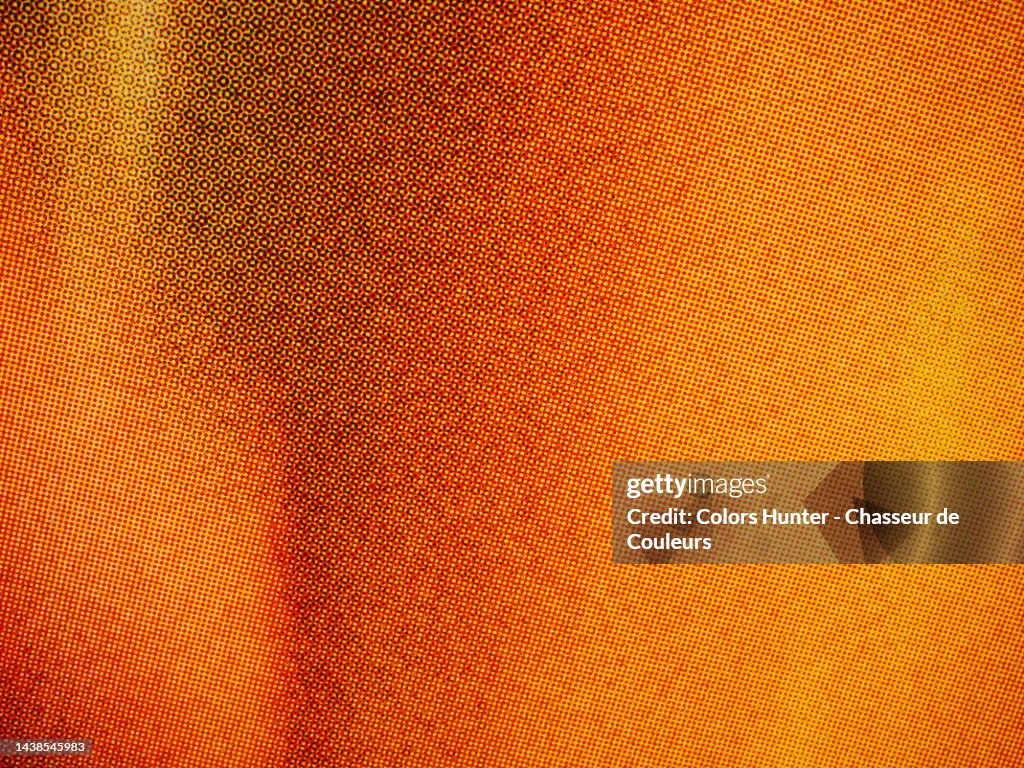 Very close-up of a poster in orange tones printed using the offset technique in Paris